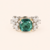 Radiating elegance and timeless charm, the Elegant Green Stone Ring features a captivating green center stone surrounded by a halo of sparkling lab-grown diamonds. Designed to make a statement, this sophisticated piece combines vibrant color, exceptional brilliance, and refined craftsmanship, making it perfect for special occasions or adding a touch of luxury to everyday style.